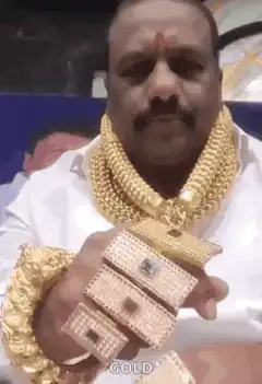 Man showing off gold jewelry