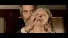 Man pulling woman's eyelids open