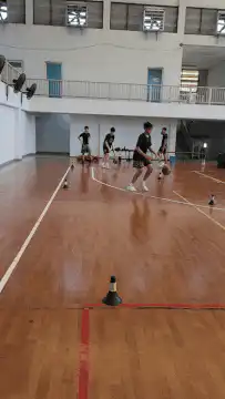 Basketball players practicing drills in gym