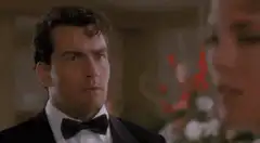 Charlie Sheen adjusting his bow tie