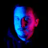 Man's face under blue and red lights