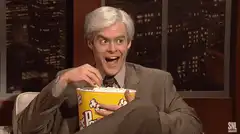 Bill Hader eating popcorn with wide eyes