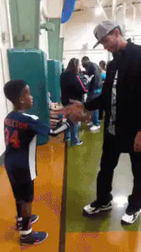 Kid and man do a complex handshake