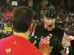 Stone Cold Steve Austin screams at a masked wrestler
