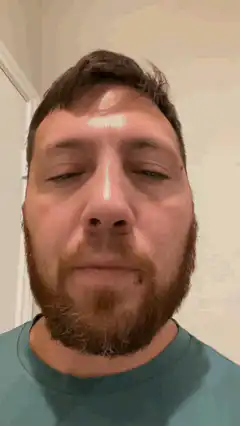Man with closed eyes and shiny forehead