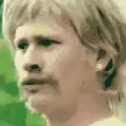 Man with mustache blinking and talking