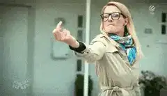 Woman in glasses pointing and dancing