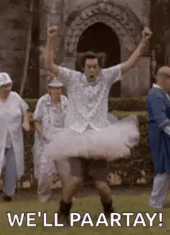 Man in tutu celebrating with arms raised