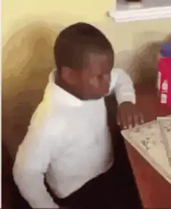 Boy slams book on desk in frustration