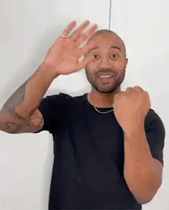 Man waving and pointing excitedly