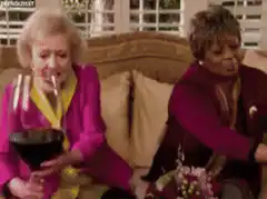 Betty and Vivian toast with giant wine glasses
