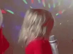 Baby singing into microphone with disco lights