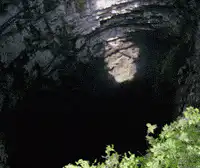 Man falling into a deep dark hole