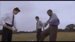 man kicks laptop with bat
