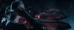 Bald man drinks from red glowing cups