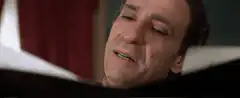 Man sneezes into handkerchief