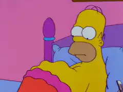 Homer Simpson in bed looking confused