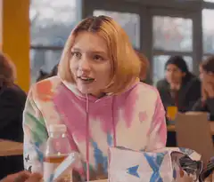 Girl in tie-dye hoodie reacts with shock