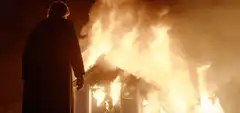 Man watching house burn