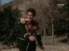 Man in uniform chased by people in red helmets