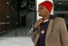 Man in red beanie coughing