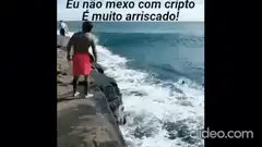 Man jumps into ocean wave with crypto text