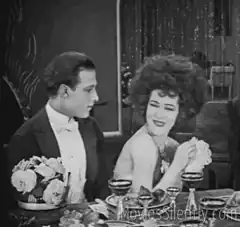 Couple dining with woman laughing