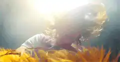 Child headbanging in hay