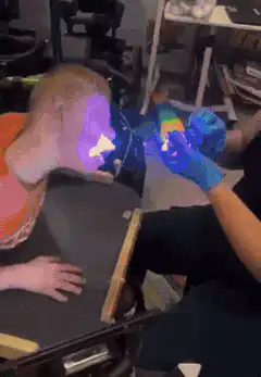 Person with glowing face from UV light