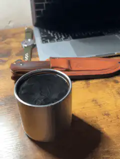 Steam rising from a metal cup