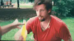 Man chugs yellow drink and smiles