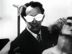 Man in white glasses dancing