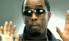 Sean Combs dancing with hands up