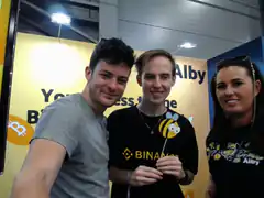 Three people at a Binance Alby event