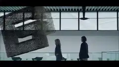 Woman touches particle cube