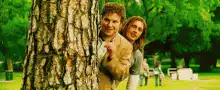 Dude and Stifler peeking from behind a tree