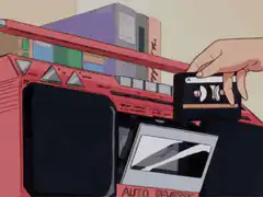 Hand inserting cassette into boombox