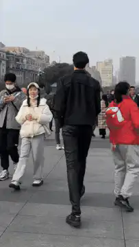 Man walking through crowd on city street