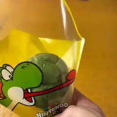 Yoshi green treat in Super Nintendo World bag