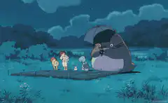 Totoro holding an umbrella in the rain