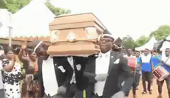 Dancing pallbearers carrying coffin
