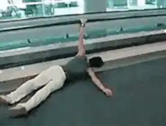 Man lying on bowling lane