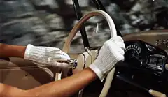 woman driving car with white gloves