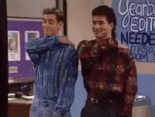 Two guys flexing arms