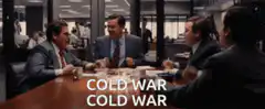 Men in suits fist bumping Cold War