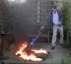 Man vacuuming a fire in the garden