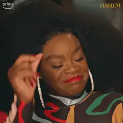 Woman with big afro hair touching her head