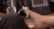 Dwight Schrute drinks coffee with his foot