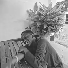 man laughing on bench