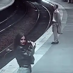 Woman dancing on train platform
